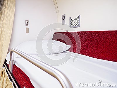 White pillow on upper storey bed in Thai second class sleeper cabin train Stock Photo