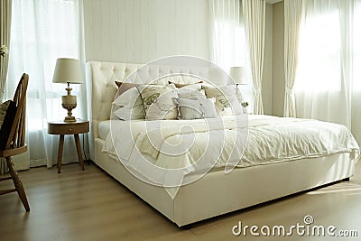 White pillows setting on English country style bedding Stock Photo