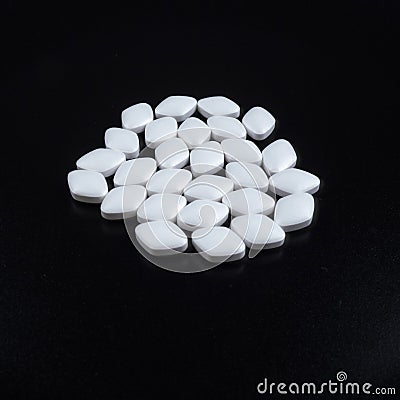 White Pills on black background Stock Photo