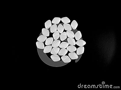 White Pills on black background Stock Photo