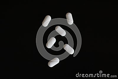 Pills on a black background. Stock Photo