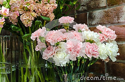 white and pink carnations close bouquet on showcase Stock Photo