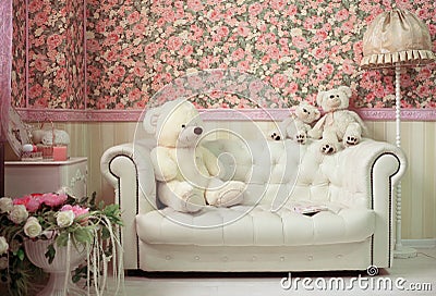 White and pink cozy room with flowers teddy bears white sofa and lamp Stock Photo