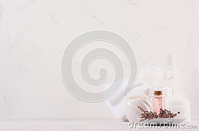 White and pink delicate cosmetics products for body and skin care in white modern bathroom on shelf, copy space. Stock Photo