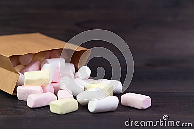 White and pink marshmallows spill out of the package Stock Photo