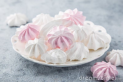 White and pink meringues on white plate Stock Photo