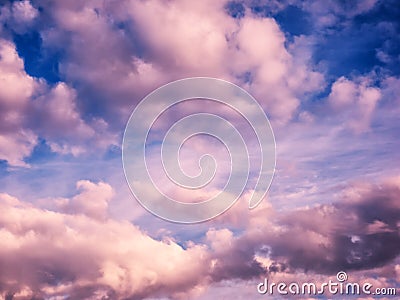 White and pink puffy clouds in blue sky Stock Photo