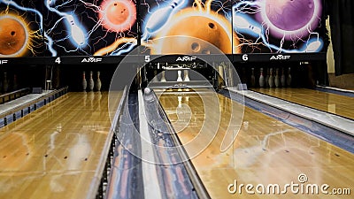 White pins and the wooden bowling alley, active cport games and leisure concept. Media. Skittles being lifted by the Editorial Stock Photo