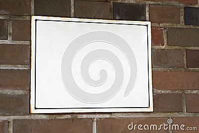 White plaque on a brick wall with space for text. Informant pointer. Signboard copy space Stock Photo