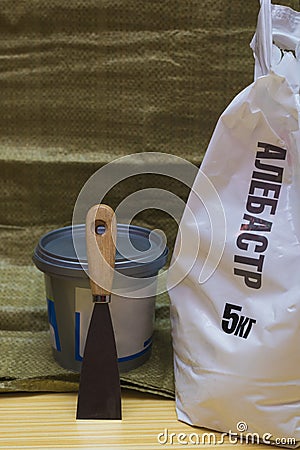 White plastic bag of alabaster 5 kilograms, plastic bucket with Stock Photo