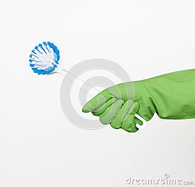 White plastic cleaning brushes in hand, protective green glove on hand Stock Photo