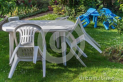 White plastic furniture garden chair table children kids lawn Stock Photo