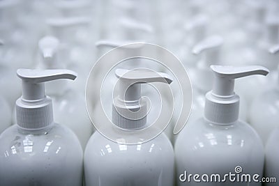 White plastic soap bottles in rows assembly line Stock Photo