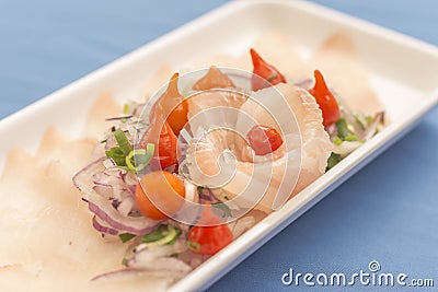 White plate with white fish sashimi on blue background Stock Photo