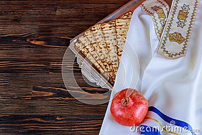White plate with matzah or matza and Passover Haggadah on a vintage wood Stock Photo