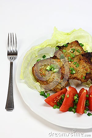 Grilled pork chops with tomatoes and lettuce Stock Photo