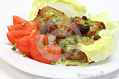 Grilled pork chops with tomatoes and lettuce Stock Photo