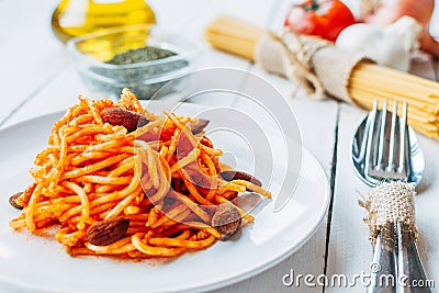 White plate with spaghetti on a table with foods of the typical food of the diet Stock Photo