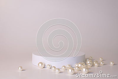 White podium on the white background with pearls. Podium for product, cosmetic presentation. Creative mock up. Pedestal Stock Photo