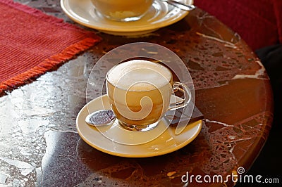 White porcelain Cup with gourmet coffee on marble table in Italian bar. Stock Photo