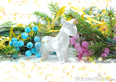 White porcelain unicorn figurine, christmas decorations, christmas tree , copy space Stock Photo