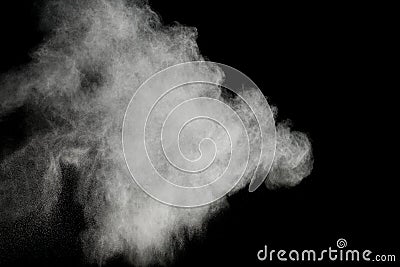 White powder explosion on black background.Stopping the movement of white powder on dark background. Stock Photo