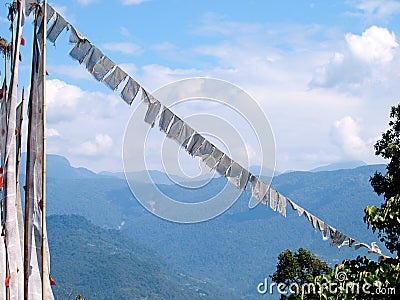 White prayer flags over a clear blue sky in India Stock Photo