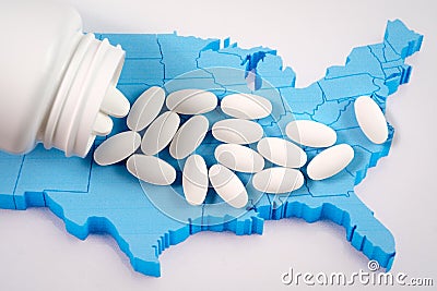 White prescription pills spilling from medicine bottle over map of America Stock Photo