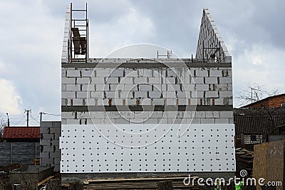 White private unfinished brick house on a construction site on the street Stock Photo