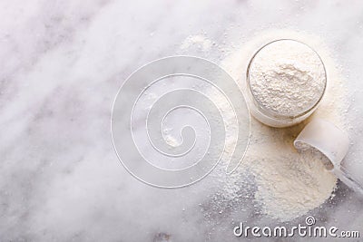 White protein powder in jar with measuring spoon Stock Photo