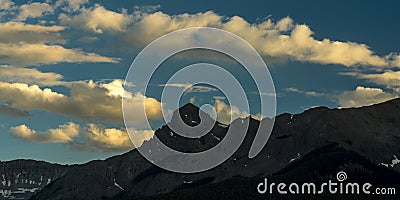 White puffy clouds go by S9 Mountain, Hastings Mesa, Ridgway/Telluride Colorado Stock Photo