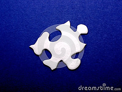 White Puzzle Piece on Blue Stock Photo