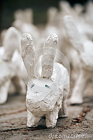 White rabbit statues made of plaster close up, outdoor art exhibition, artificial white hares Editorial Stock Photo