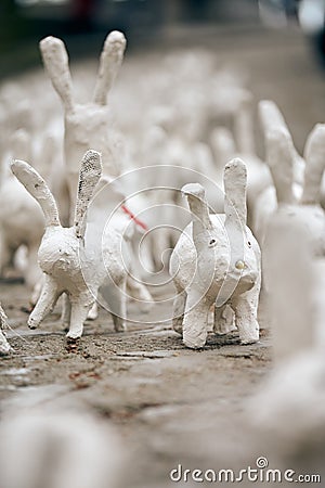 White rabbit statues made of plaster at outdoor art exhibition, funny white hares on street Editorial Stock Photo