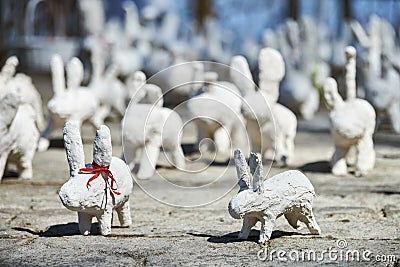 White rabbit statues made of plaster at outdoor art exhibition, funny white hares on street Editorial Stock Photo