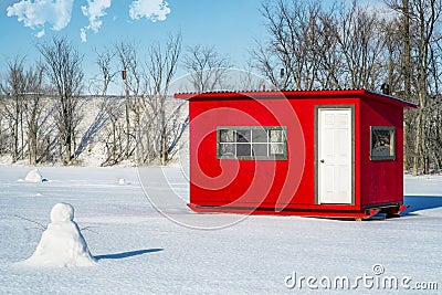 White and Red Ice Fishing Cabin in Ste-Rose Stock Photo