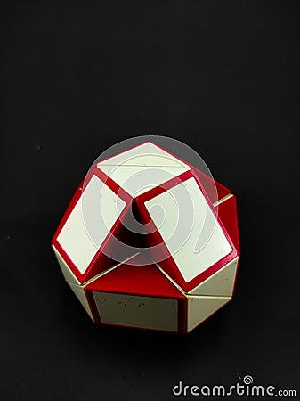 White and red rubik's toy isolated on a black - Stock photo Editorial Stock Photo