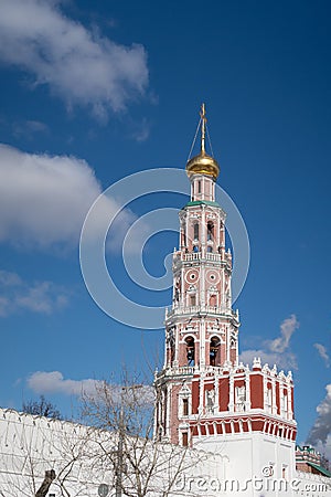 White and red watchtower and white wall against the background of the bell tower of the Novodevichy Convent, Moscow Stock Photo