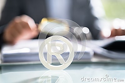 White Registered Trademark Sign Near Documents Stock Photo