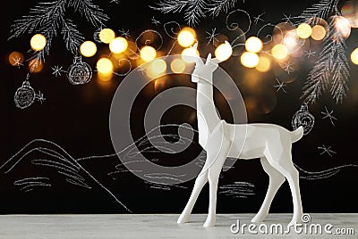 White reindeer on wooden table over chalkboard background whith hand drawn chalk illustrations. Cartoon Illustration