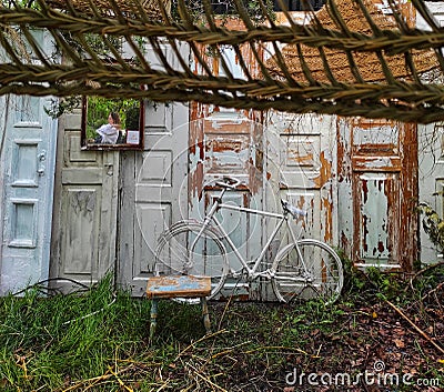 Garden location old vintage doors and white bike Stock Photo