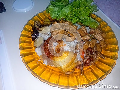 white rice complete with side dishes on the plate Stock Photo