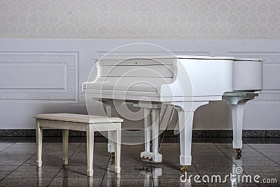 White room with white wooden grand piano and chair Stock Photo