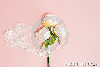 White roses with ribbon over the pink background. Stock Photo