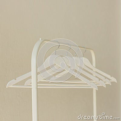 White row of hangers on the rack. Stock Photo