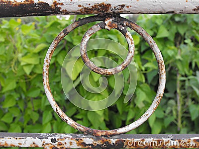 White rusty metallic banister overlooking a garden Stock Photo