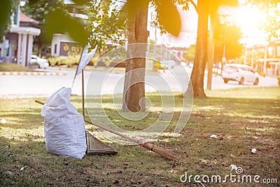White sacks are used to contain dead leaves that have fallen seasonally in spring as way to clean park and mix leaves to make Stock Photo