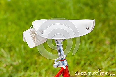 White saddle with saddlebag on red vintage 1970s folding bike Stock Photo