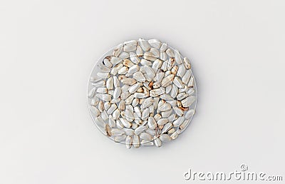 White safflower seeds. A sample of a batch of safflower seeds on a white picking board. Stock Photo