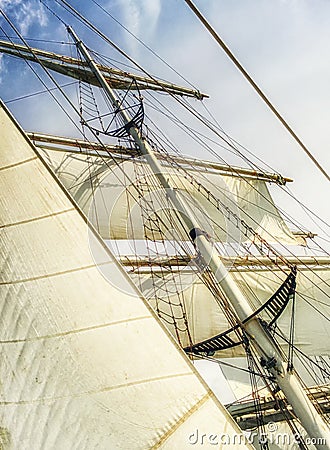 White sails, mast and ropes view from below of a classic sailing ship. Stock Photo